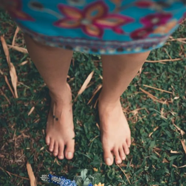 selective focus photography of person in front of yellow petaled flowers