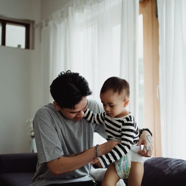 man changing his sons diaper