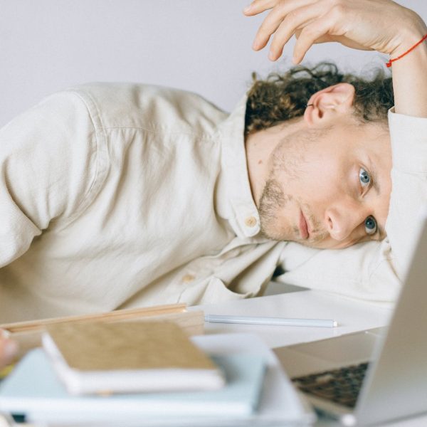 overworked employee lying in front of laptop