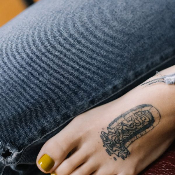 close up photo of a person s foot with a tattoo