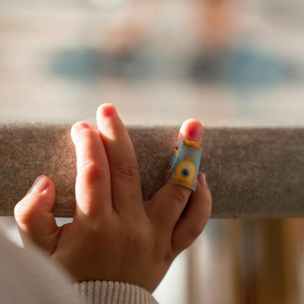 close up photo of baby s hand with bandage