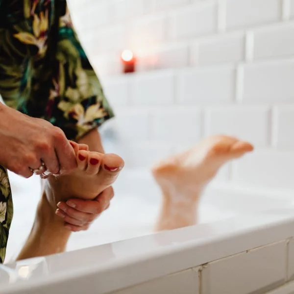 a person massaging a foot