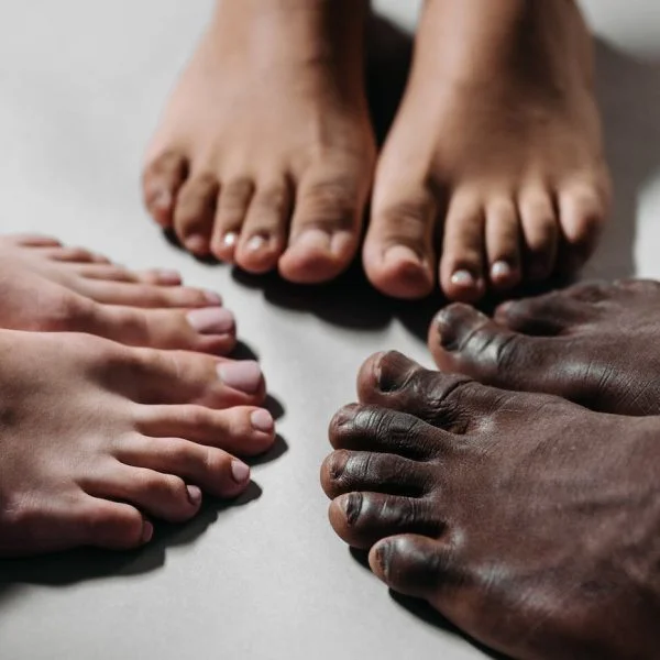 people s feet on white floor